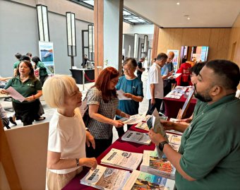 Avid travellers enquiring about PONANT expeditions during the showcase event